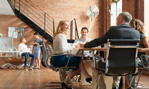 Exciting boardroom meeting with business people in trendy office space